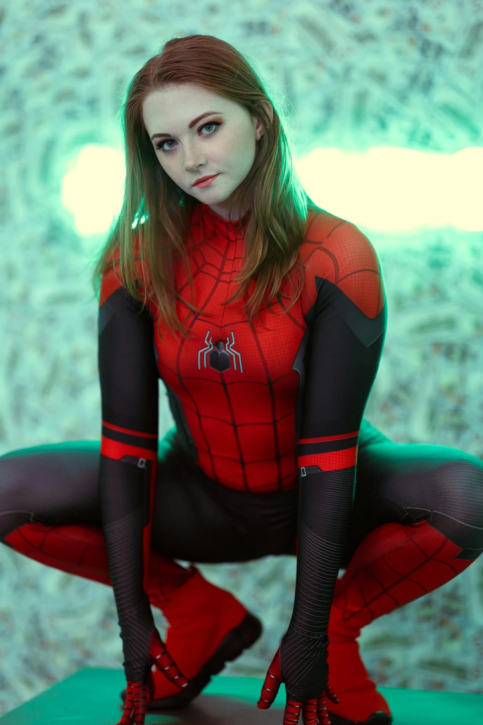 a woman in spider suit posing for a po