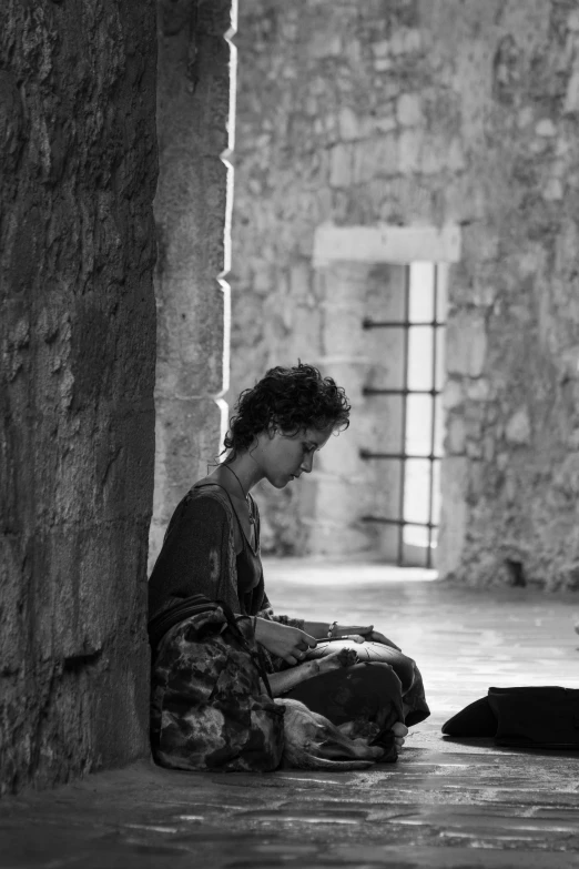 a woman sitting on the floor with her dog on her lap