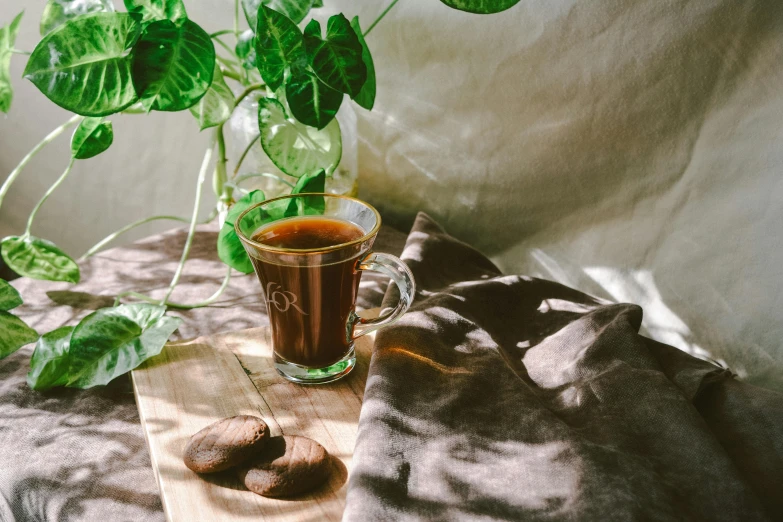 a glass of tea sitting on top of a cloth