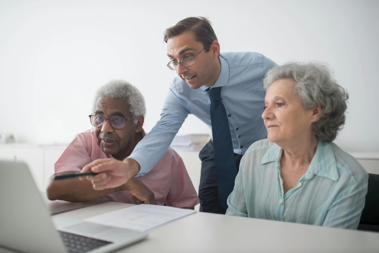 a couple of people that are at a laptop