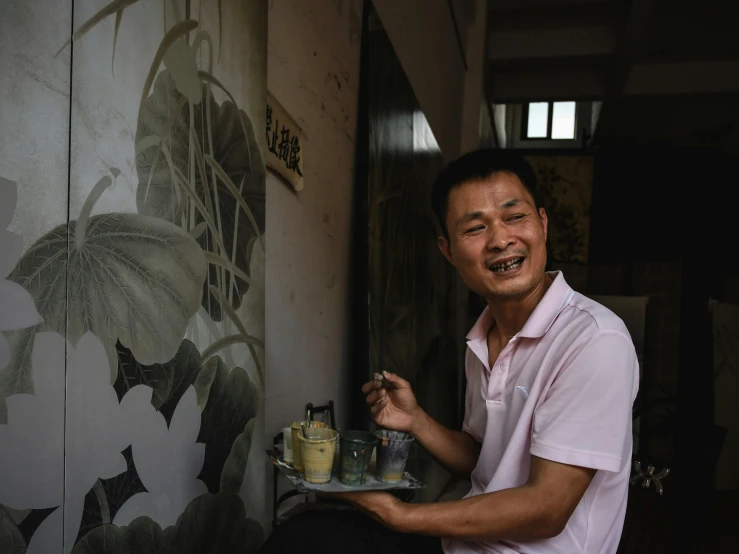 a man sitting at a table with a plate full of food