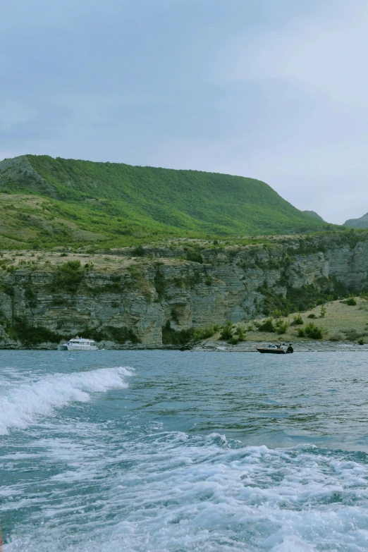 water and hills are seen along the side of a boat