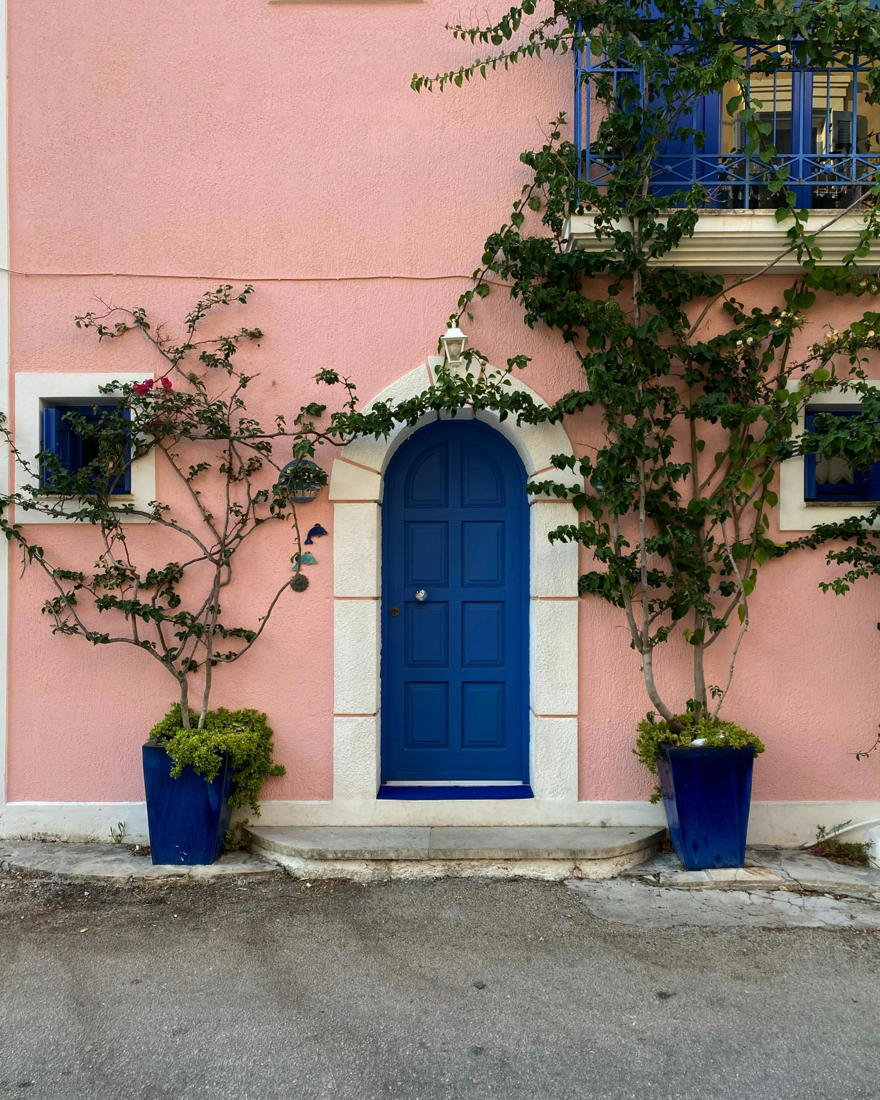 a blue door is on a pink wall