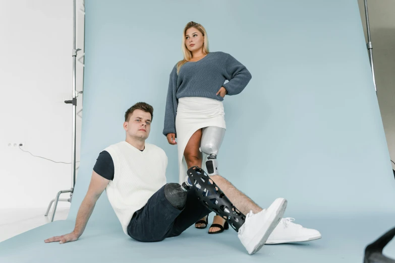 a man and woman in skirts and sweaters pose together