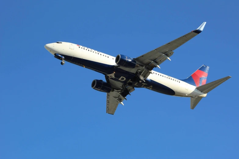 an airplane flying in the sky on a sunny day