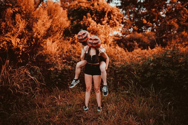 two girls are in the middle of an orange landscape