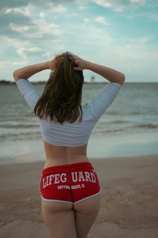 a woman with red underwear is on the beach