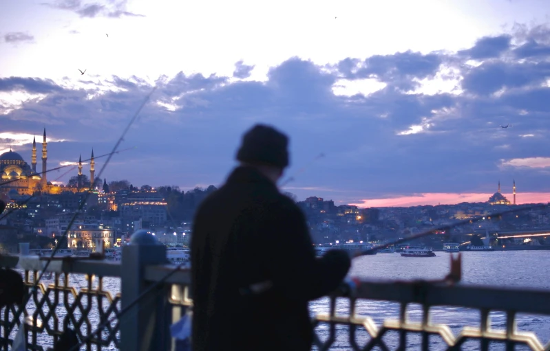 a man that is standing on the shore of a body of water