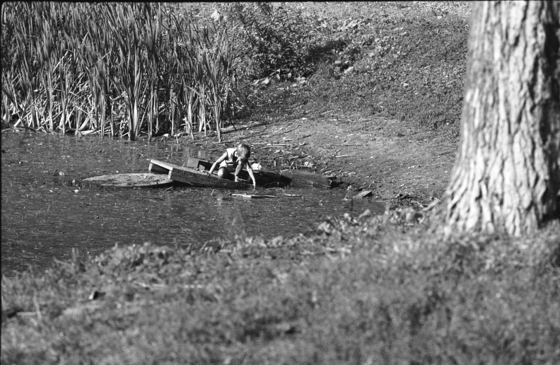 a man sitting in the water in his canoe