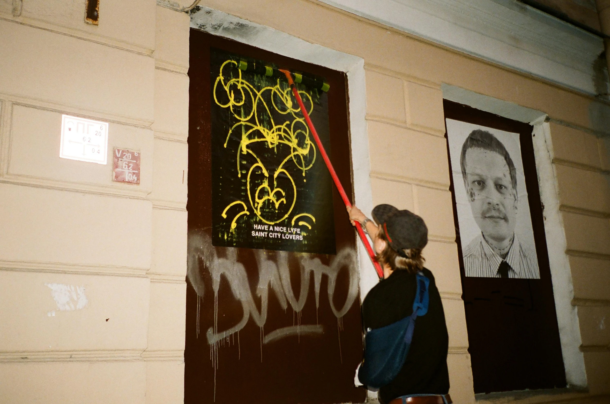 a girl is painting a building with graffitti