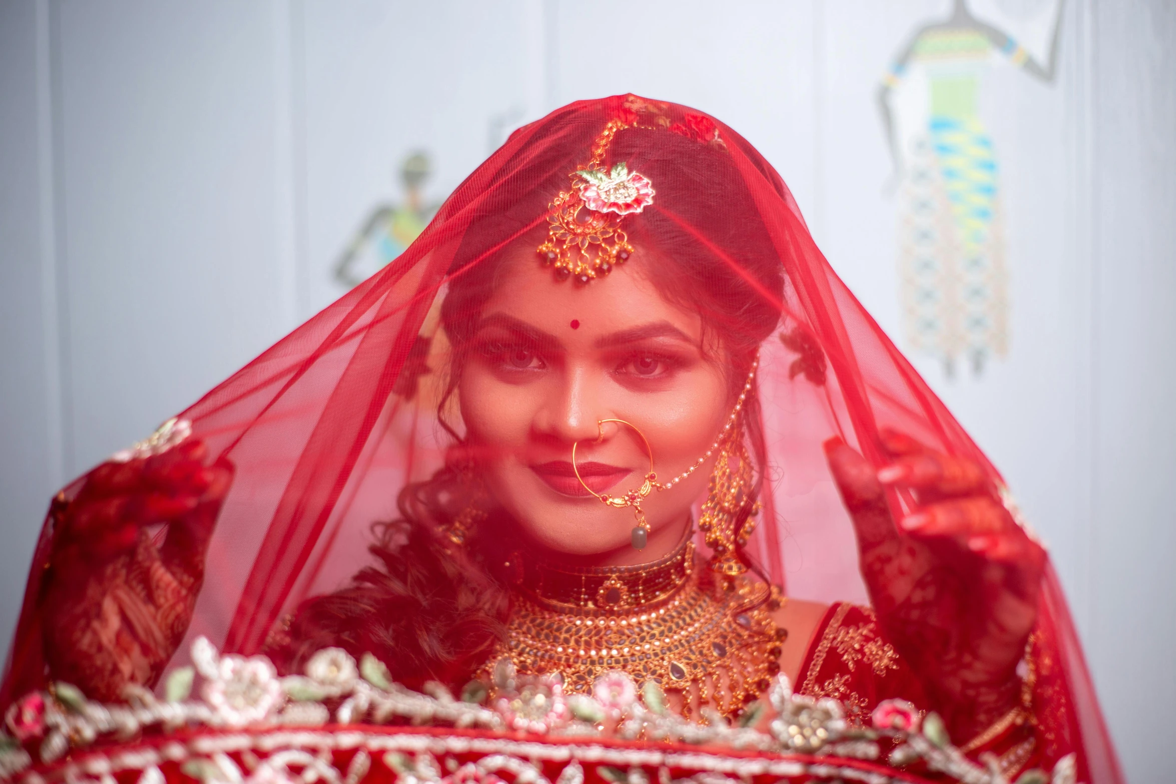 a beautiful indian bride in red posing for a picture