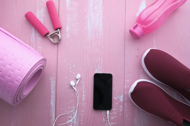 pink yoga mats and accessories laid on a table