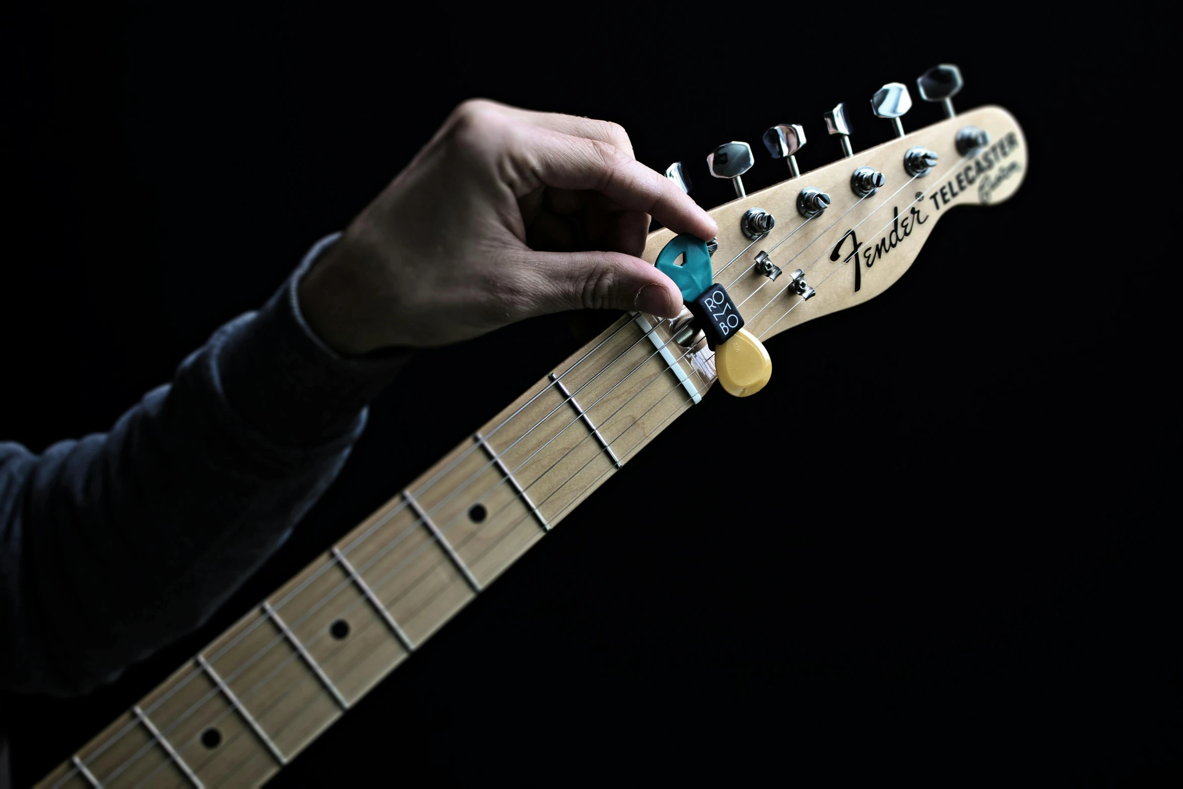 a person holding an electric guitar with his hand