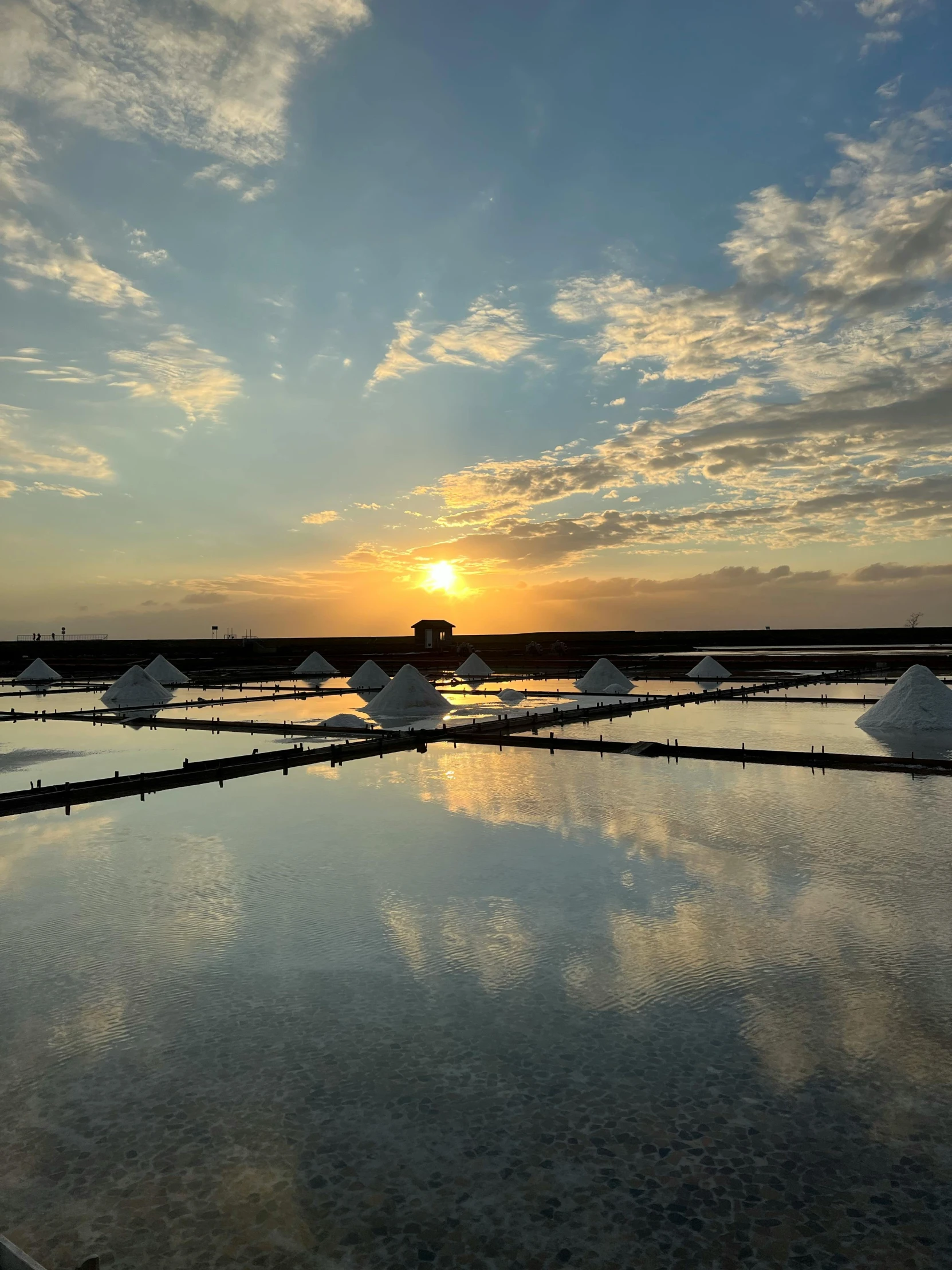 the sun shines in behind some large stones