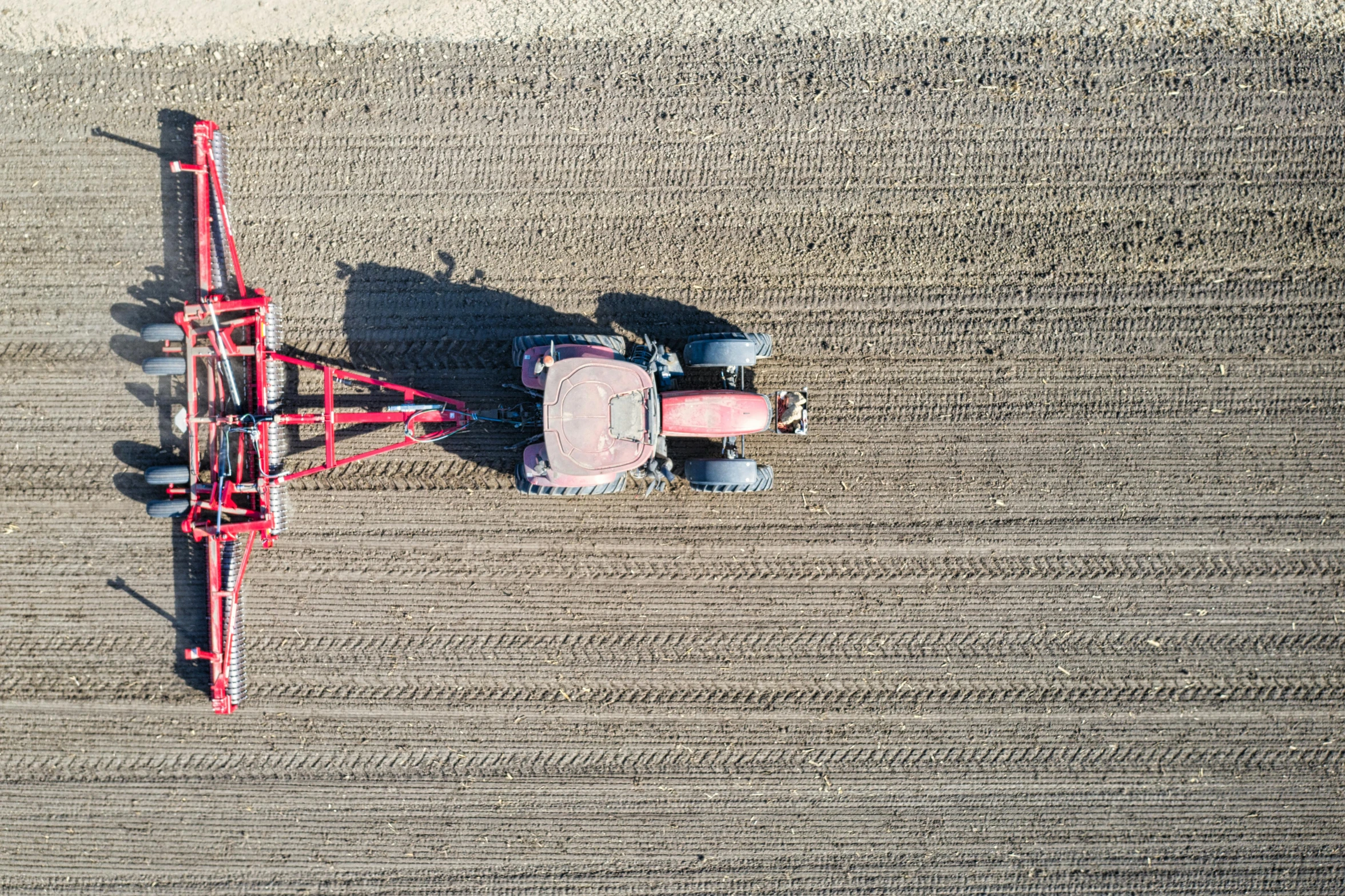 tractor working in the field with two disc harrows