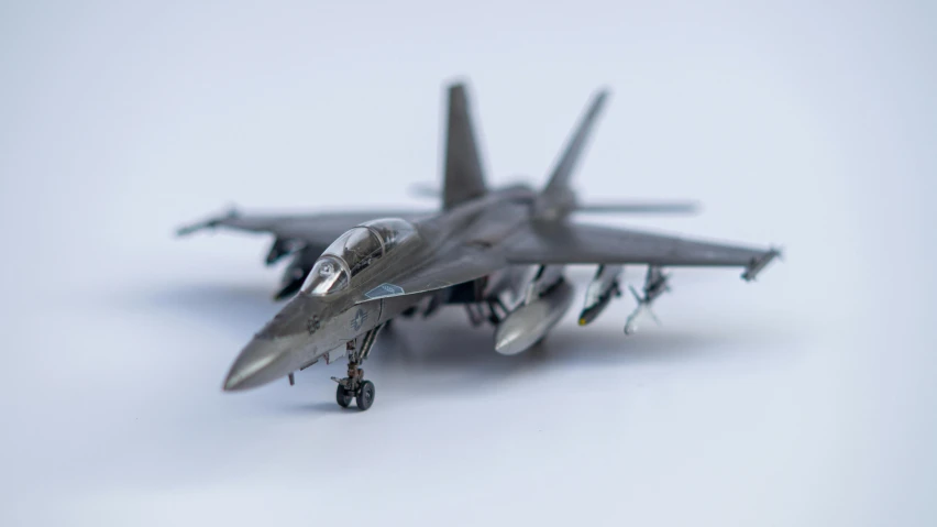 a toy model of two fighter jets on a white table