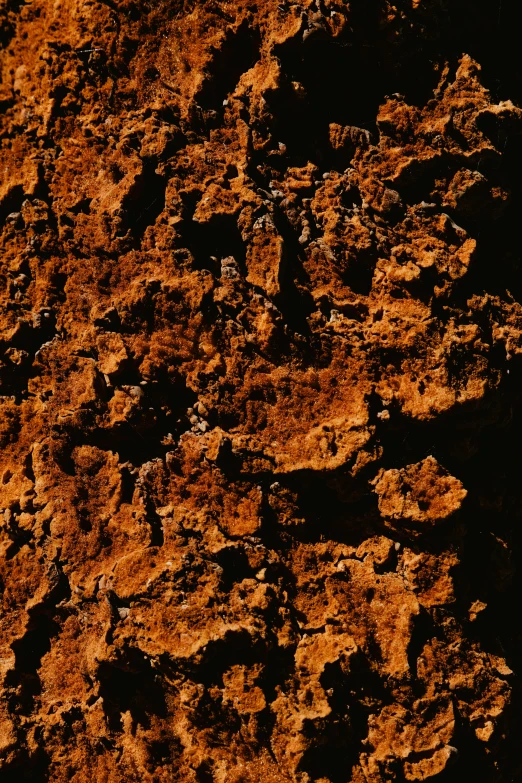 an orange, yellow and black stone surface with little scratches