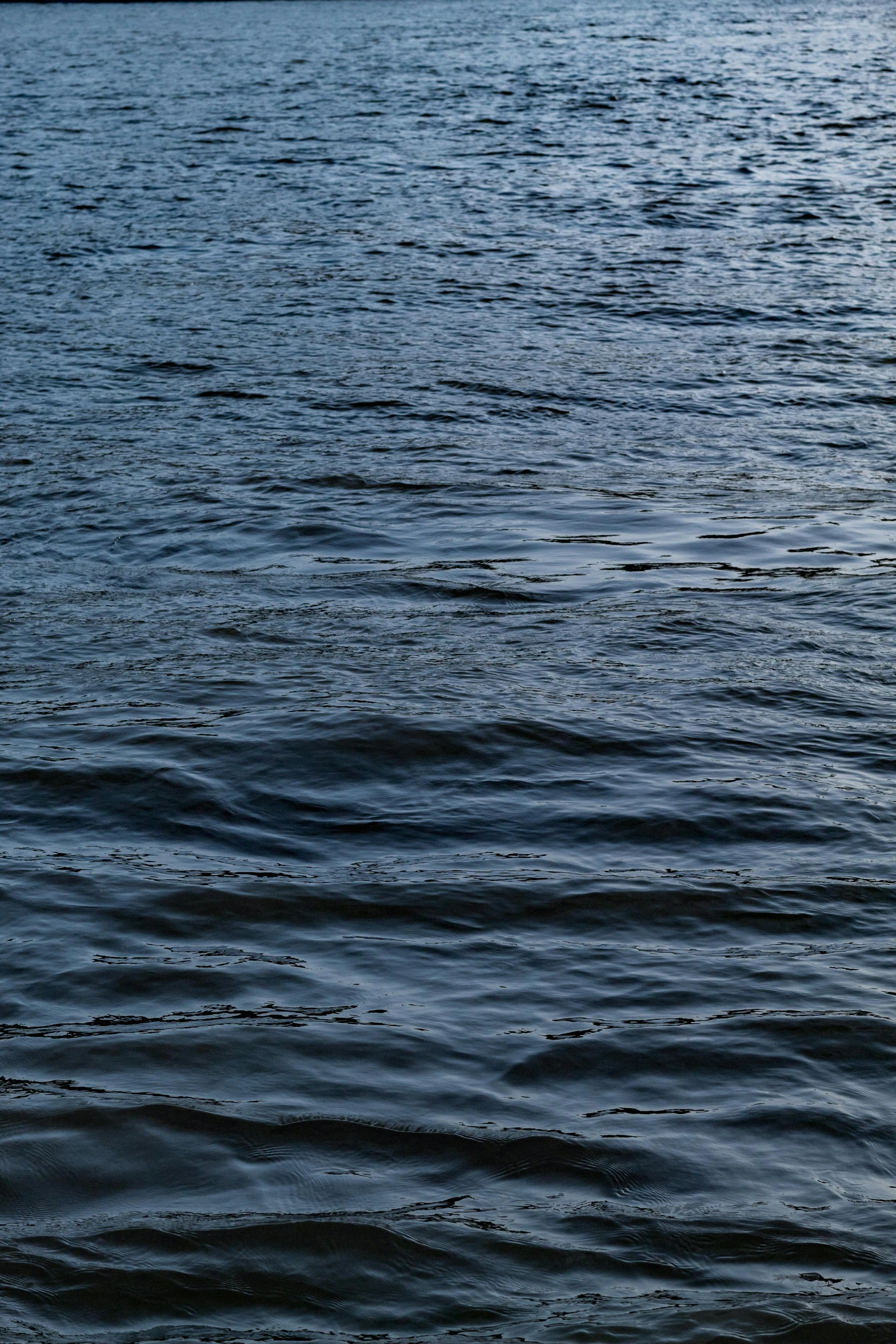 a body of water with a boat in the distance