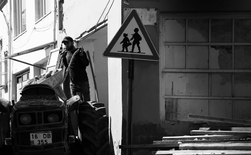 an old tractor and a man is next to a sign