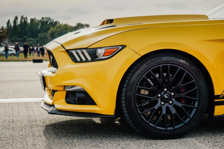 a yellow sports car is parked on the road