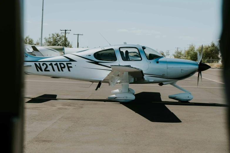 a white propeller airplane sitting on top of an airport tarmac