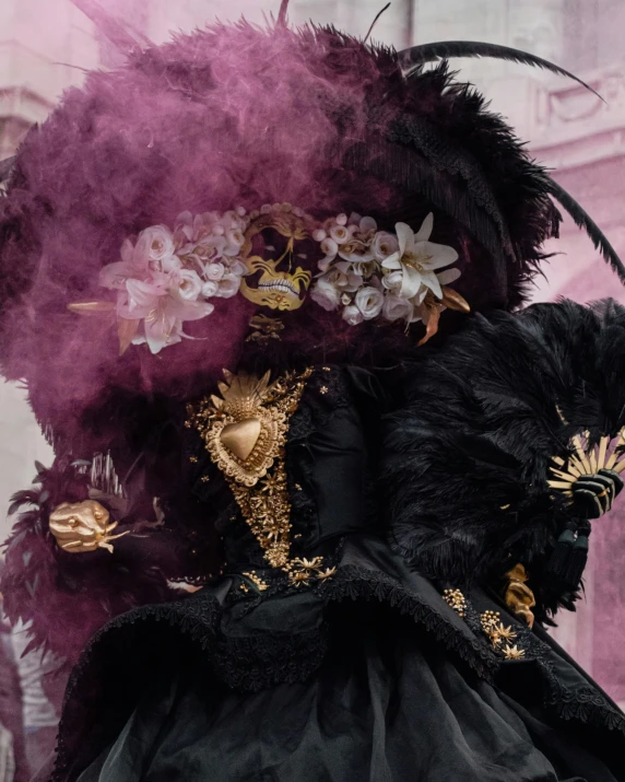 close up of a costume with feathers, flowers and roses