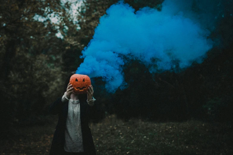 a person holding a red smoke bomb in their hand