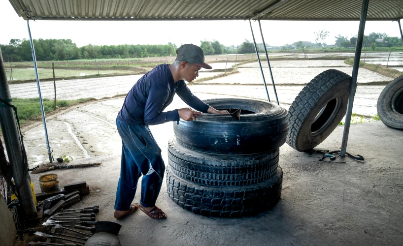 a man works on some tires for his cars