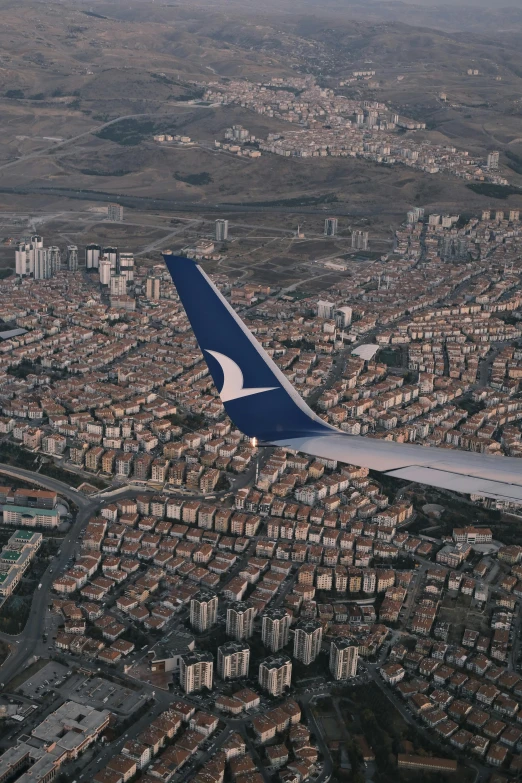 a plane flying over the city on a clear day