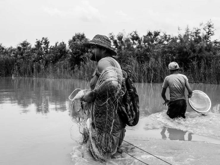 a black and white po of two people holding paddles