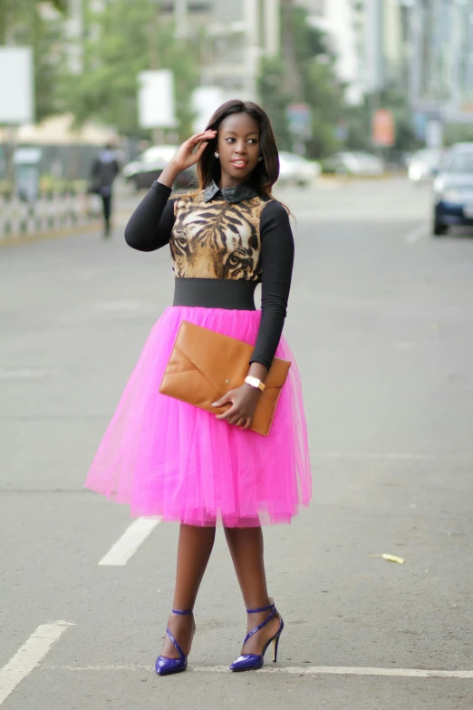 woman in a skirt and top posing on the side of the road