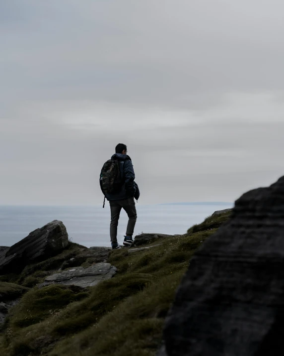 a person is walking on a rocky mountain top