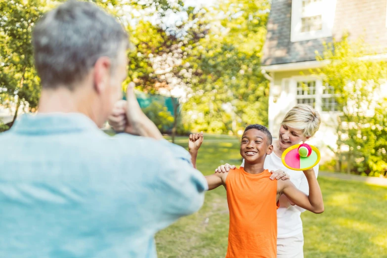 a boy and girl are playing with a frisbee