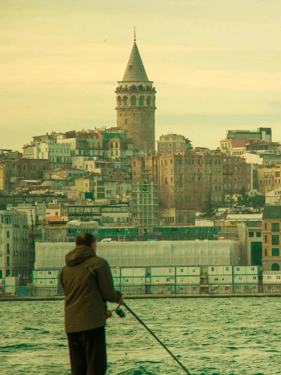 a man that is standing on a boat near water