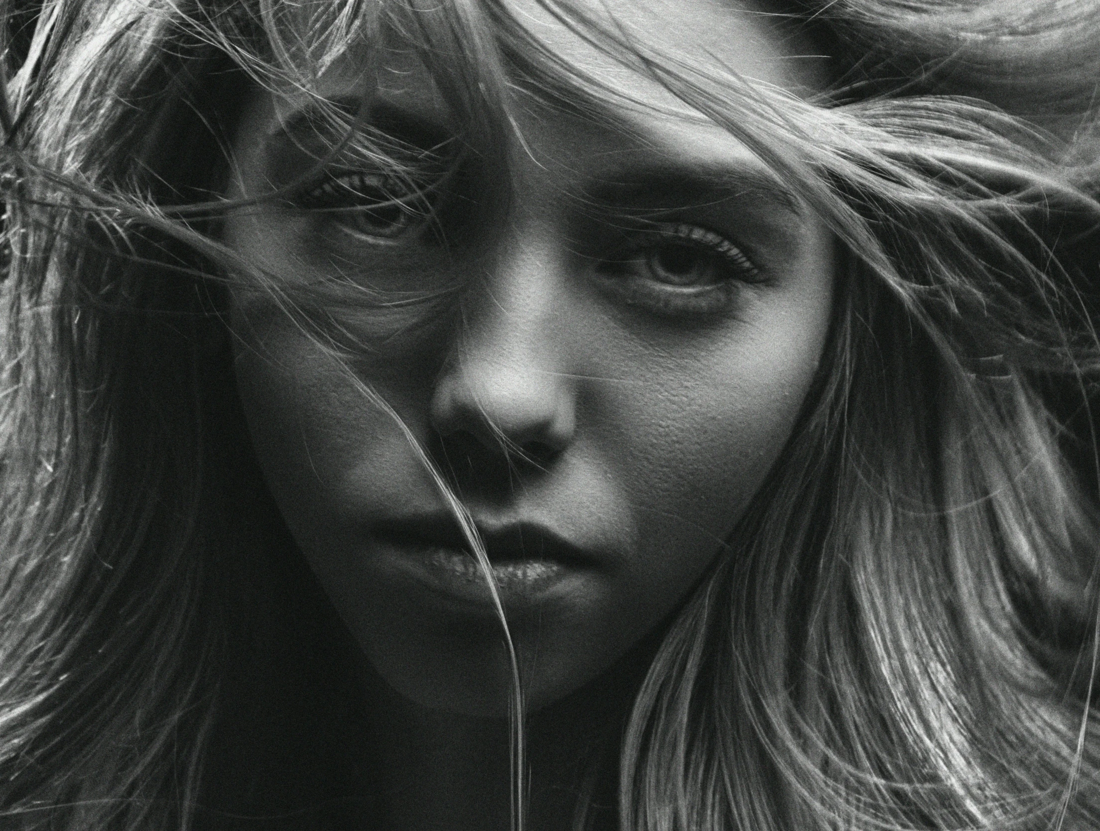 woman with long hair blowing in wind and looking to the side