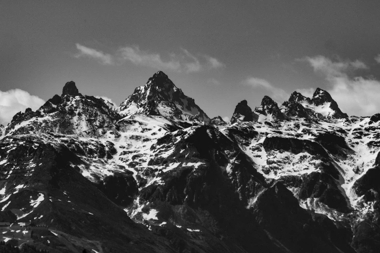 the summits of a mountain range are covered in snow