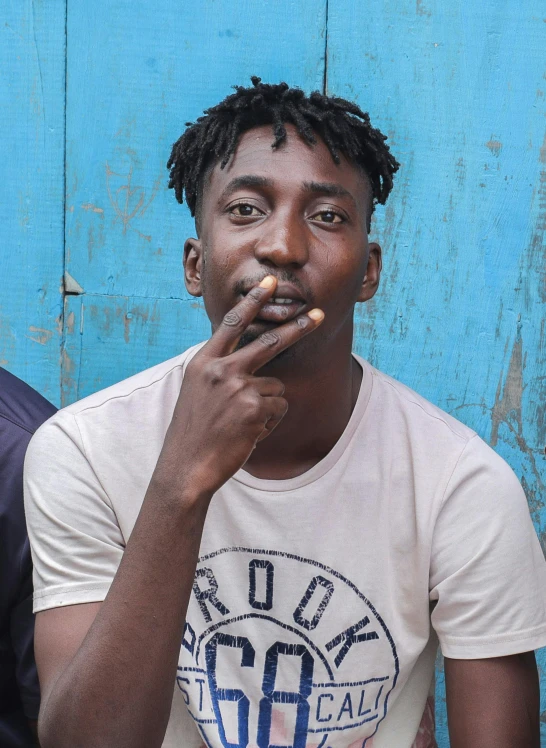 a man sitting on the floor smoking a cigarette