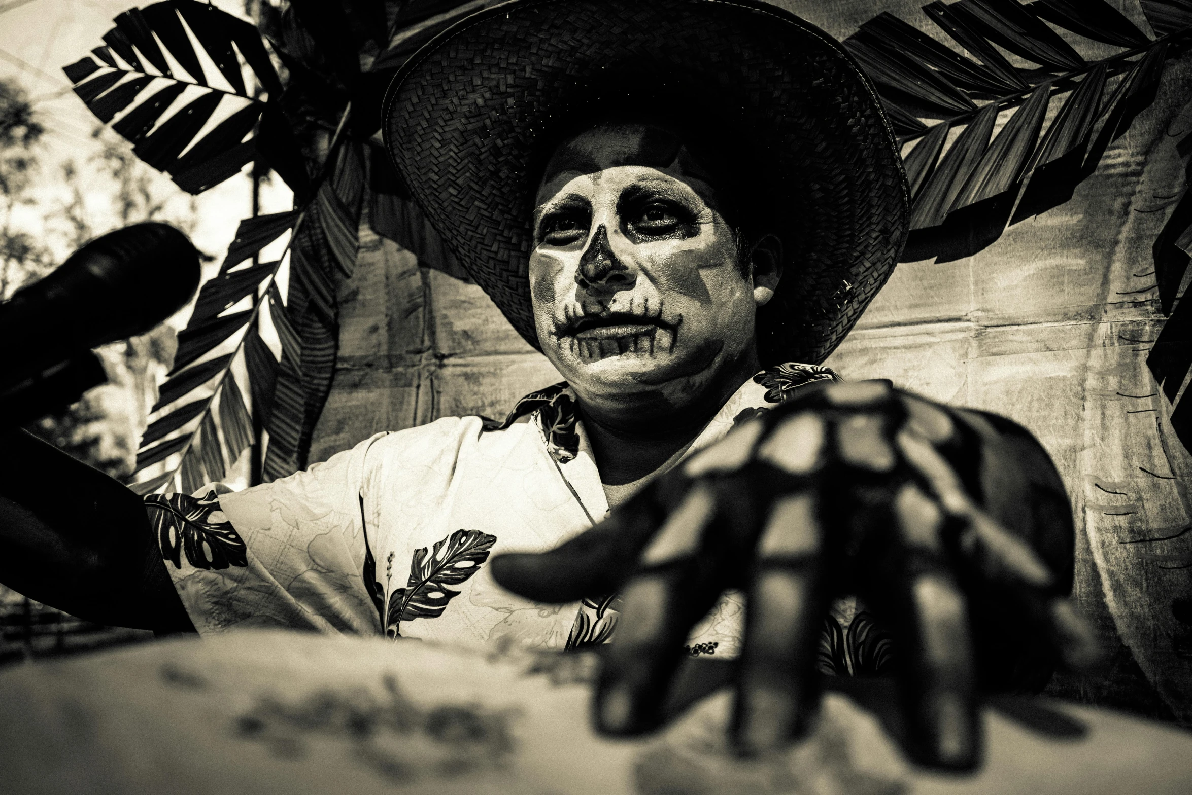 a man with face paint sitting outside