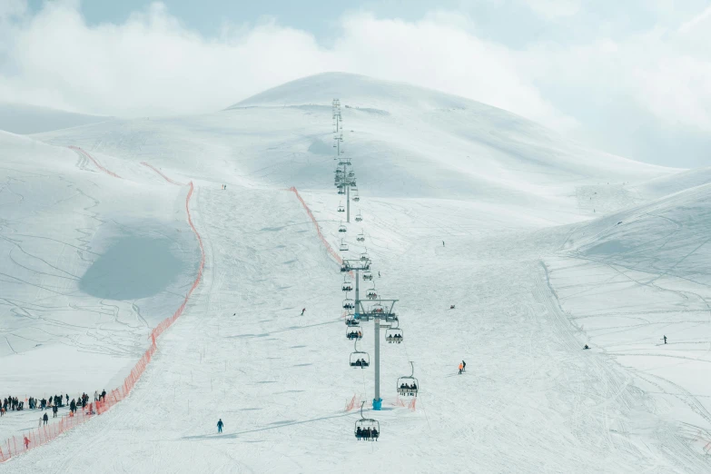 the ski lift has people on it, all standing under it