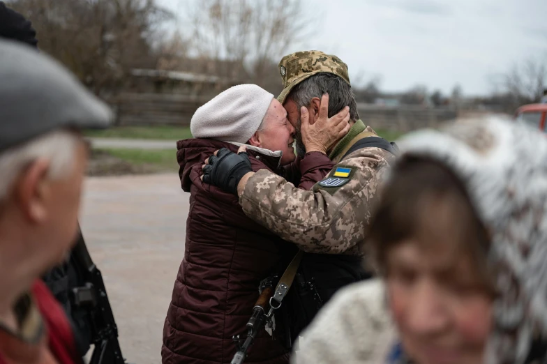 a man kissing another on the forehead