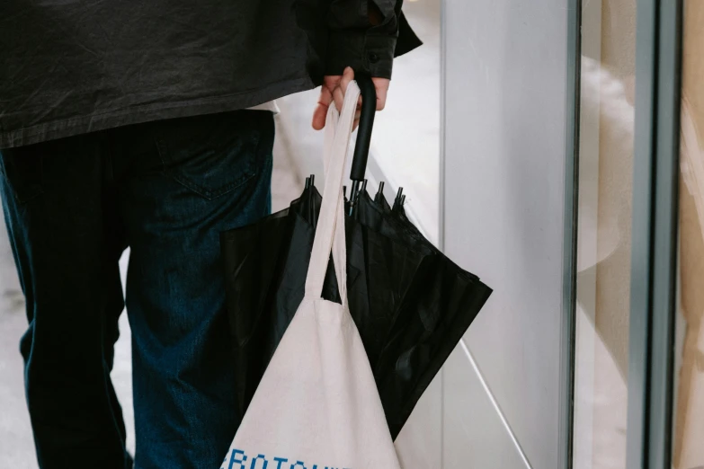 a person holding bags with the word britain printed on them