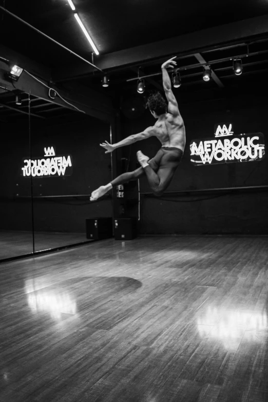 a man is on a wood floor doing acrobatics