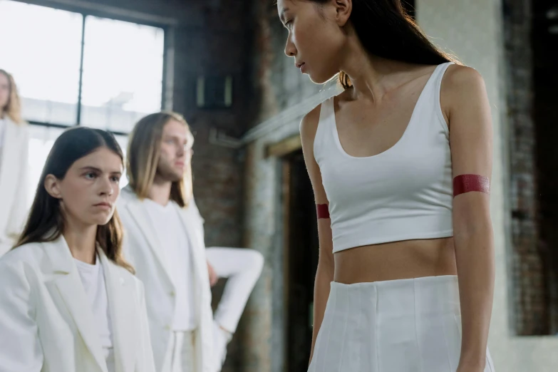 a woman standing in front of other women