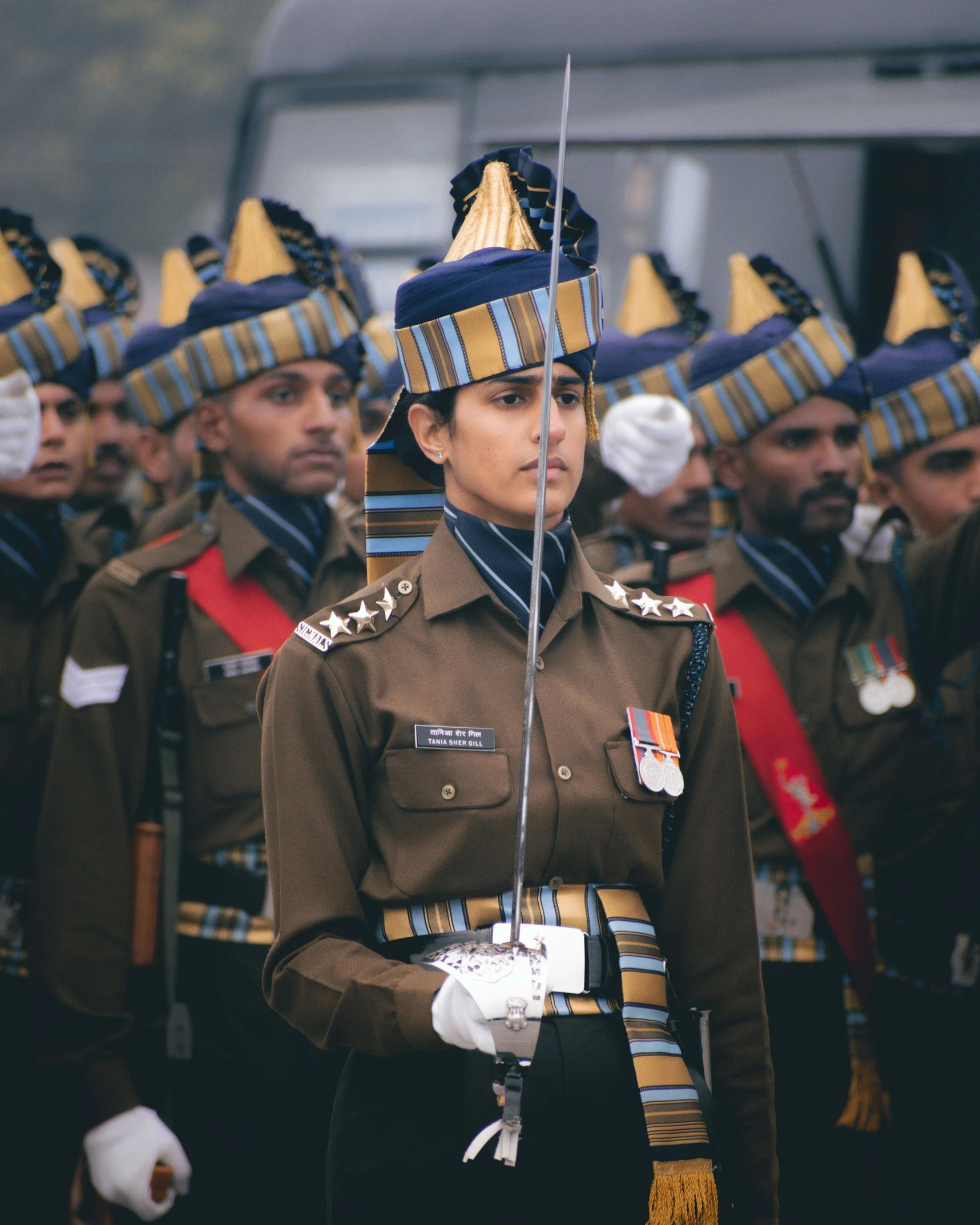 indian men in uniform lined up with their guns