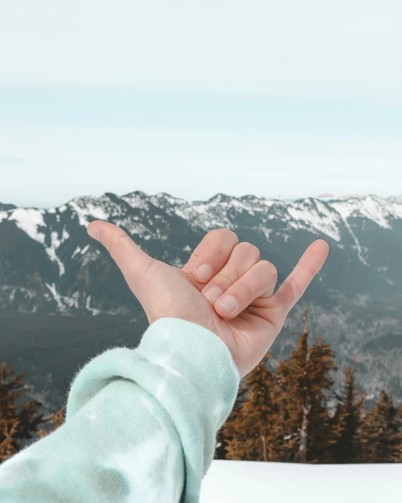 someone in the snow making an vulcan sign