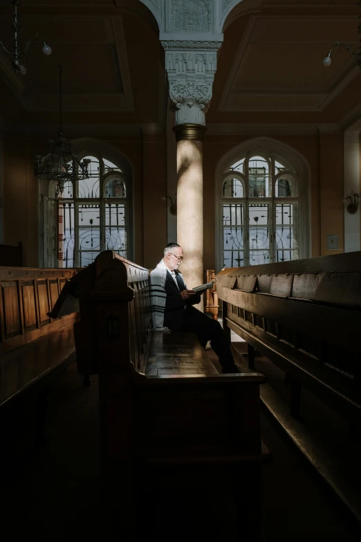 a man in a suit is sitting on a bench