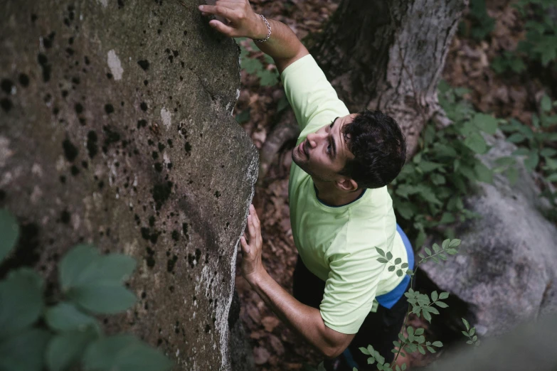 a person on a rock climbing up on some rocks