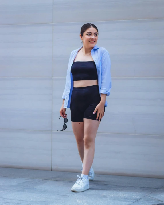 a woman is posing for a pograph while holding her purse