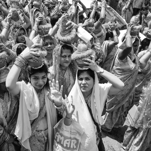 a crowd of women in the desert, with their heads covered in veils