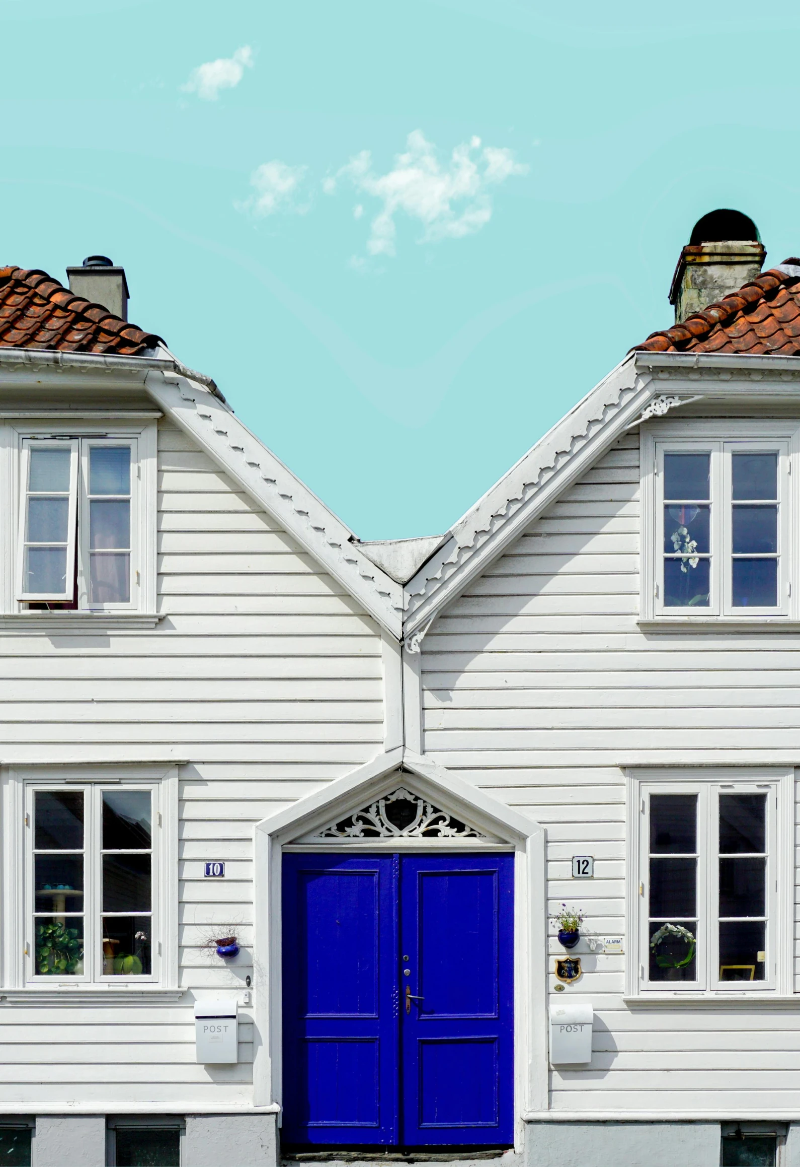 a couple of white houses with blue doors